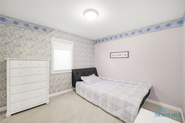 bedroom featuring baseboards, wallpapered walls, and carpet flooring