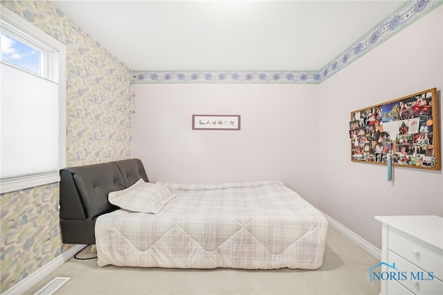carpeted bedroom with baseboards and visible vents