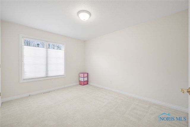 unfurnished room featuring carpet floors and baseboards