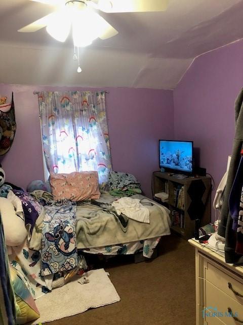 bedroom with lofted ceiling, ceiling fan, and carpet floors