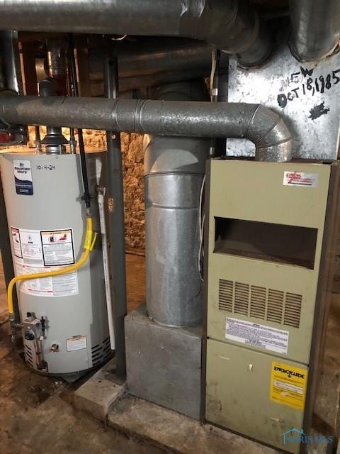 utility room featuring water heater