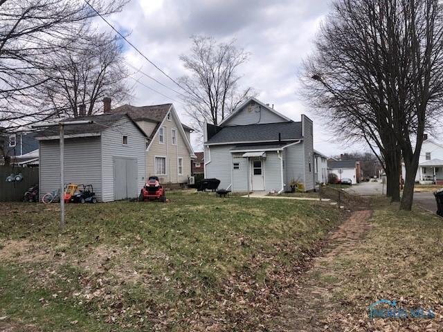 back of house with a yard