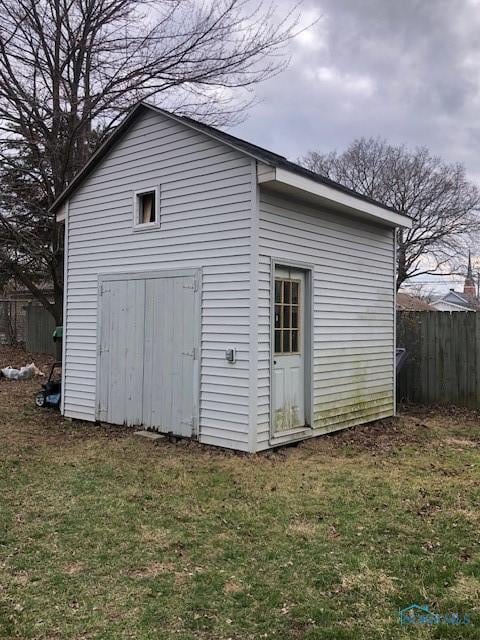 view of outbuilding featuring an outbuilding and fence