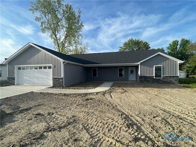 516 Ogen St, Hicksville, OH 43526 - ranch-style home with stone siding, board and batten siding, a garage, and driveway