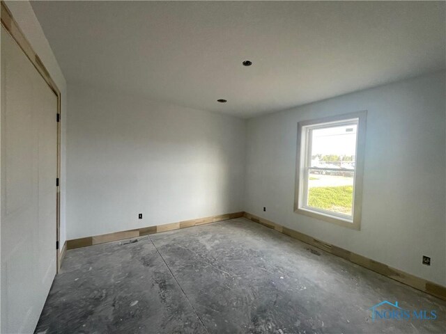 516 Ogen St, Hicksville, OH 43526 - spare room featuring baseboards and concrete flooring