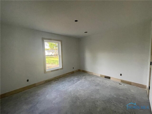 516 Ogen St, Hicksville, OH 43526 - spare room with unfinished concrete flooring and baseboards