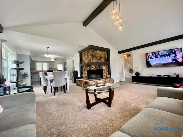 living room featuring stairs, high vaulted ceiling, a chandelier, light colored carpet, and beamed ceiling