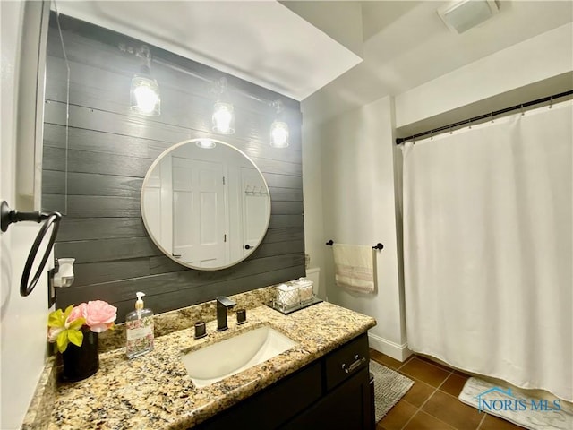 full bath with tile patterned floors, vanity, a shower with curtain, wood walls, and visible vents