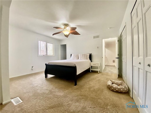 bedroom featuring visible vents, ceiling fan, and carpet flooring