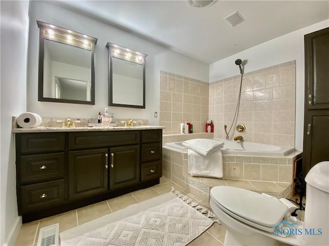 bathroom featuring tile patterned floors, toilet, vanity, visible vents, and tiled shower / bath