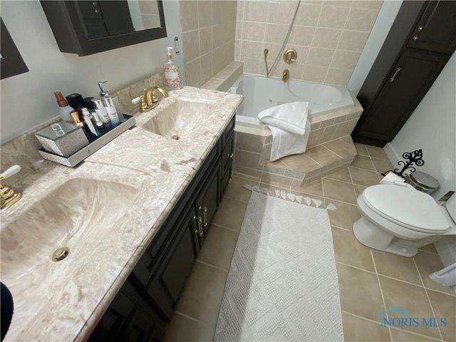 bathroom featuring double vanity, tiled tub, a sink, and tile patterned floors