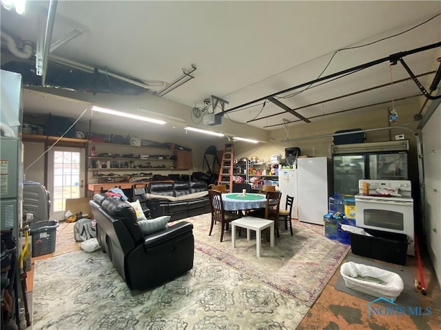 garage featuring a garage door opener and freestanding refrigerator