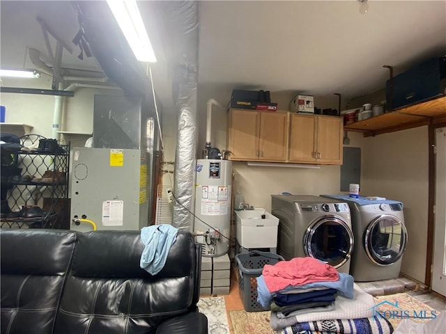 clothes washing area featuring independent washer and dryer, gas water heater, a sink, light wood-style floors, and cabinet space