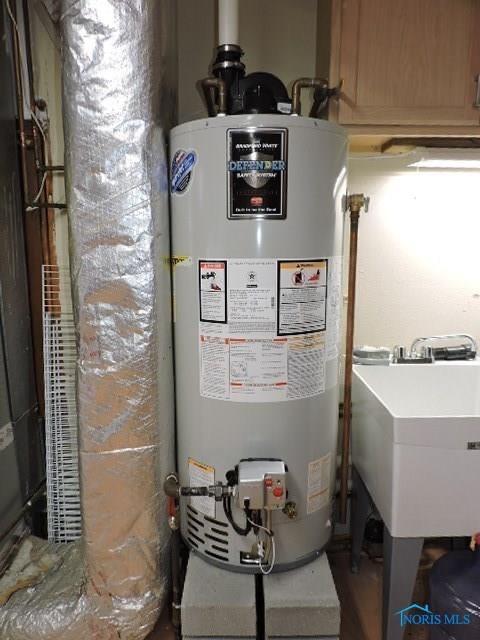 utility room featuring a sink and gas water heater