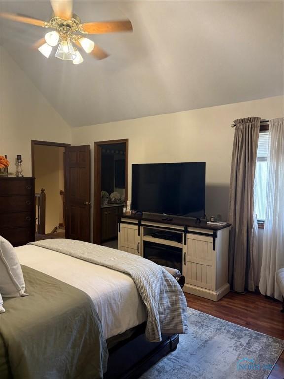 bedroom featuring lofted ceiling, wood finished floors, and a ceiling fan