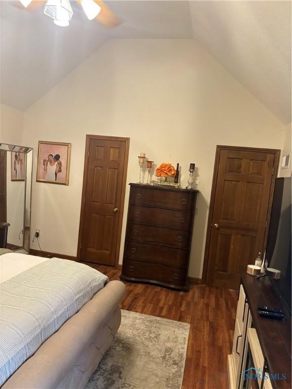 bedroom featuring dark wood-style floors and lofted ceiling