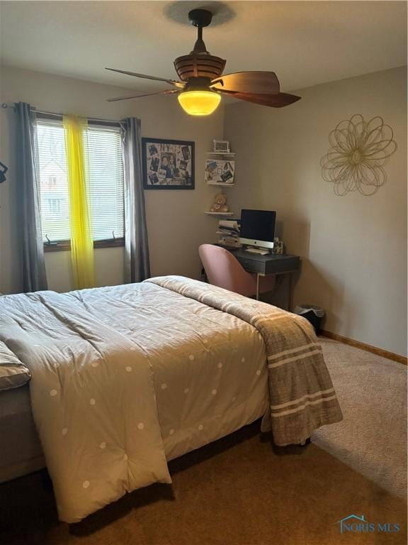 carpeted bedroom featuring a ceiling fan and baseboards