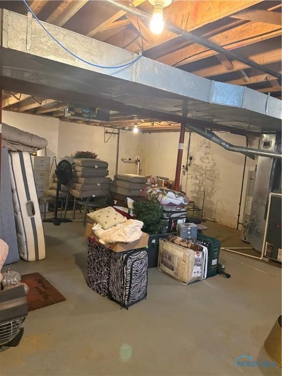 unfinished below grade area featuring heating unit
