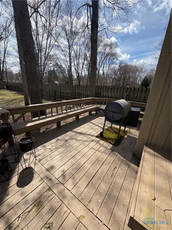 wooden terrace featuring fence