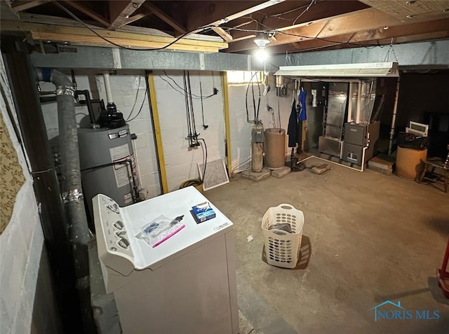 unfinished basement featuring fridge, heating unit, and gas water heater