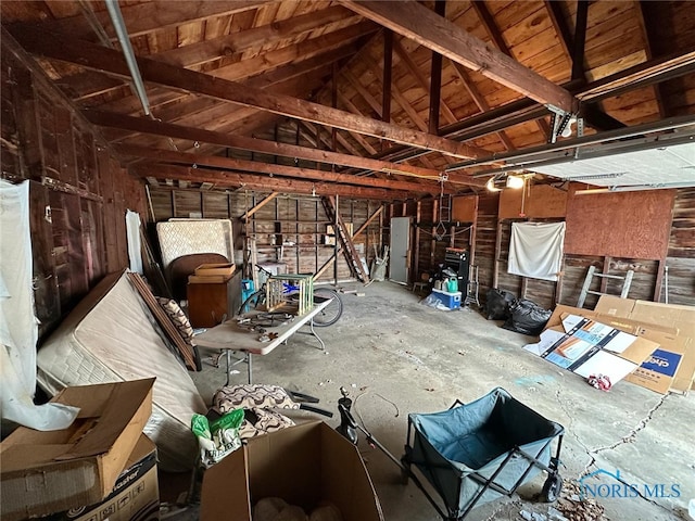 miscellaneous room featuring a garage and lofted ceiling