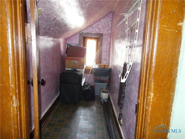 interior space featuring tile patterned floors and vaulted ceiling