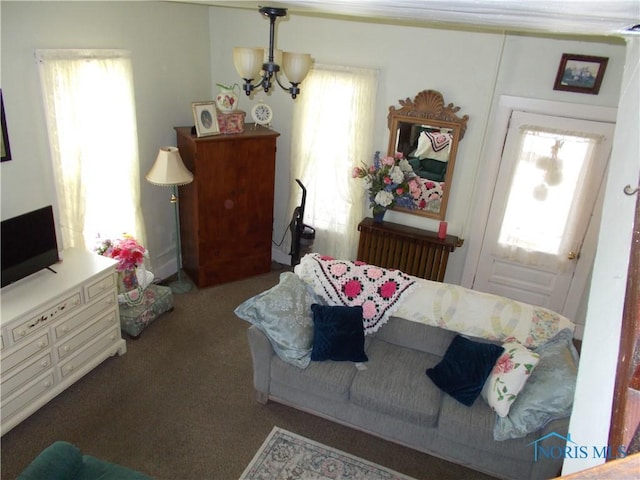 carpeted living room featuring an inviting chandelier