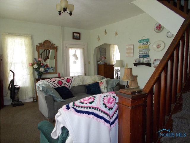 carpeted living room featuring stairway and plenty of natural light