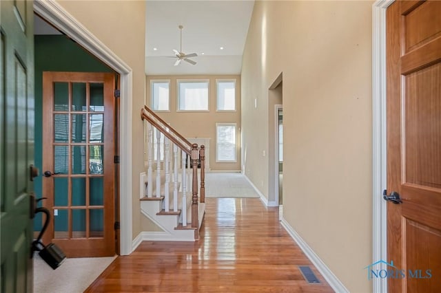 14579 Lake Meadows Dr, Perrysburg, OH 43551 - foyer featuring stairway, baseboards, light wood-style floors, ceiling fan, and visible vents