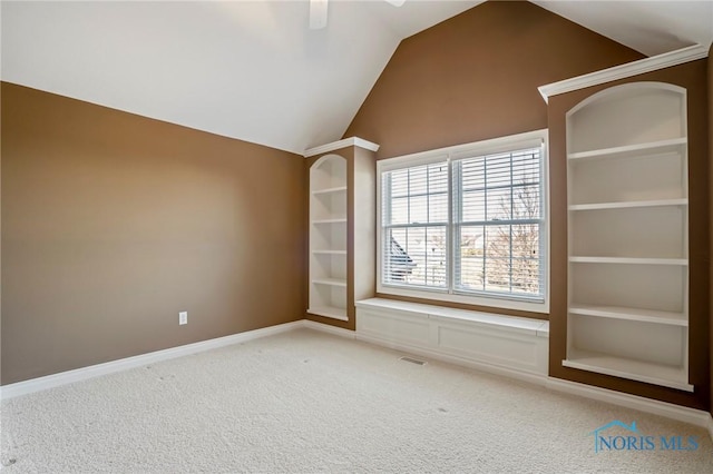 14579 Lake Meadows Dr, Perrysburg, OH 43551 - carpeted spare room with baseboards, visible vents, built in shelves, and vaulted ceiling