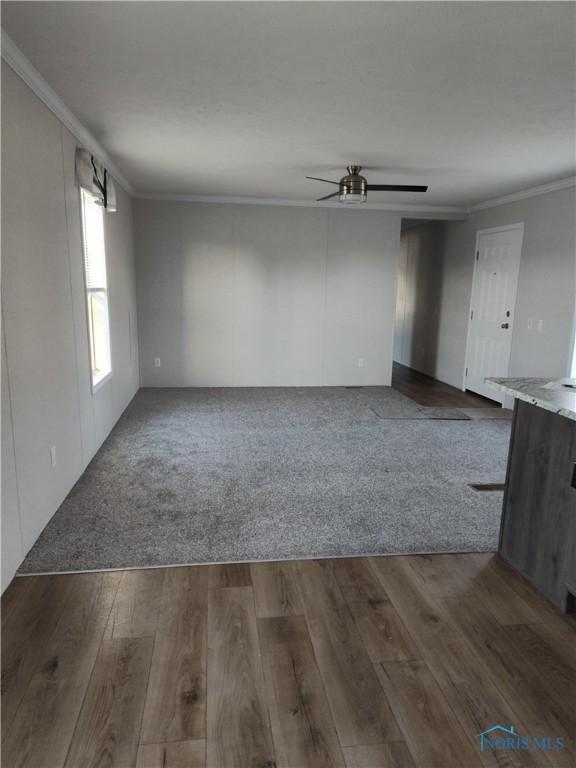 600 S Union St, Bryan, OH 43506 - spare room with dark wood-type flooring, a ceiling fan, and crown molding