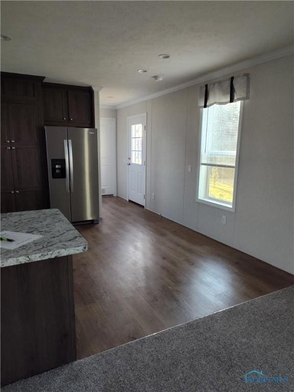 600 S Union St, Bryan, OH 43506 - kitchen with crown molding, stainless steel fridge with ice dispenser, light stone countertops, dark brown cabinets, and wood finished floors
