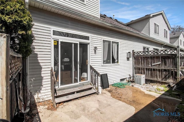 rear view of property with a patio, fence, and entry steps