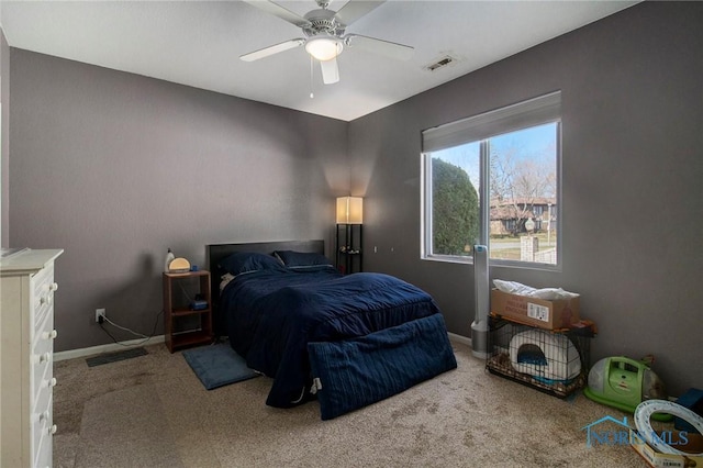 carpeted bedroom featuring baseboards, ceiling fan, and visible vents