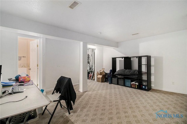 carpeted office space with baseboards and visible vents