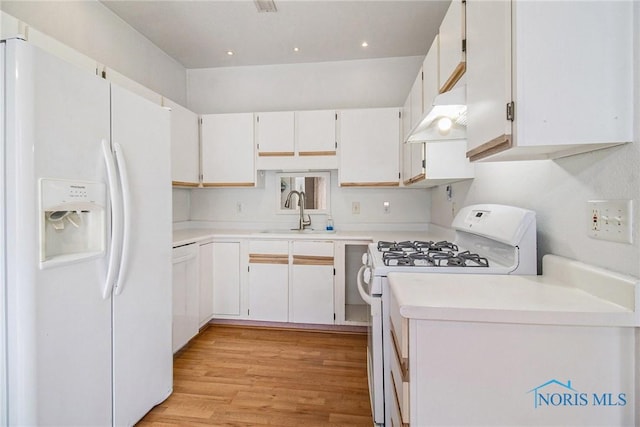 4014 Stonehenge Dr Unit 4014, Sylvania, OH 43560 - kitchen with white appliances, a sink, light wood-type flooring, light countertops, and under cabinet range hood