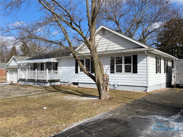 ranch-style house featuring covered porch, crawl space, aphalt driveway, and an attached garage