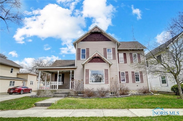 406 N Main St, Continental, OH 45831 - victorian-style house featuring covered porch and a front lawn