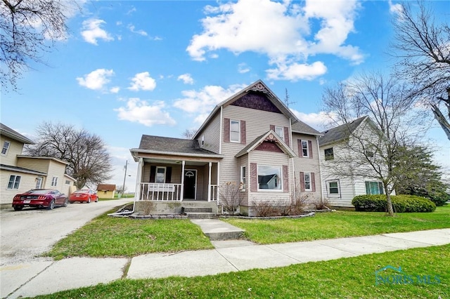 406 N Main St, Continental, OH 45831 - view of front of home with a front yard and a porch