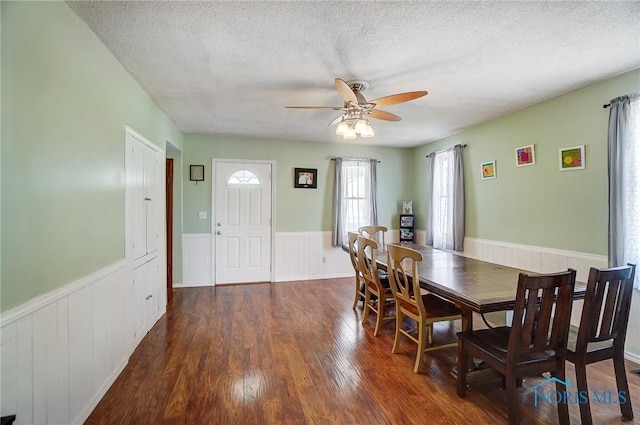 406 N Main St, Continental, OH 45831 - dining space featuring a wainscoted wall, a textured ceiling, wood finished floors, and a ceiling fan