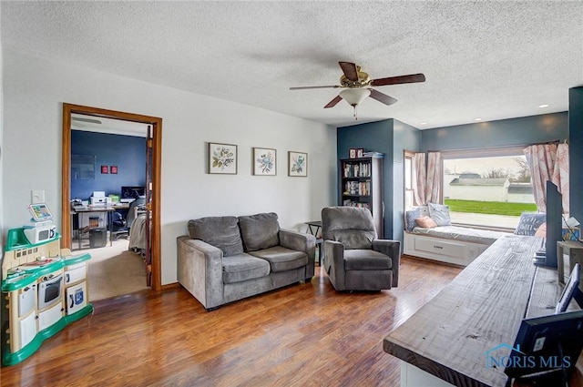 406 N Main St, Continental, OH 45831 - living room featuring wood finished floors, a textured ceiling, and ceiling fan