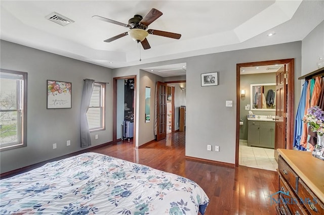 406 N Main St, Continental, OH 45831 - bedroom featuring a tray ceiling, baseboards, a sink, hardwood / wood-style flooring, and visible vents