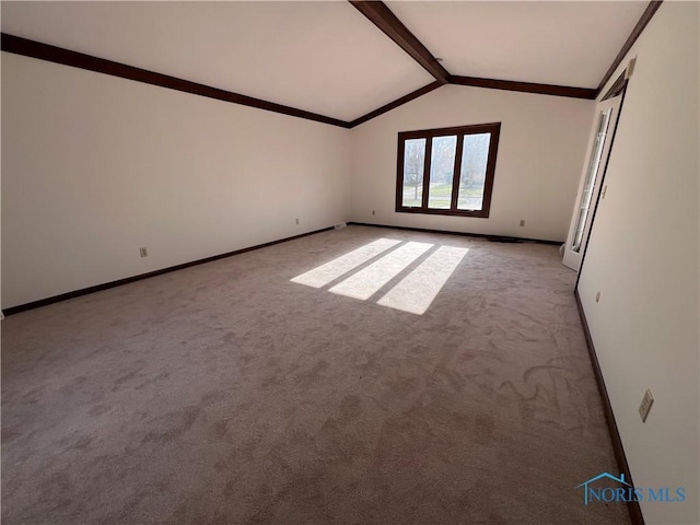 spare room featuring light carpet, vaulted ceiling with beams, and baseboards