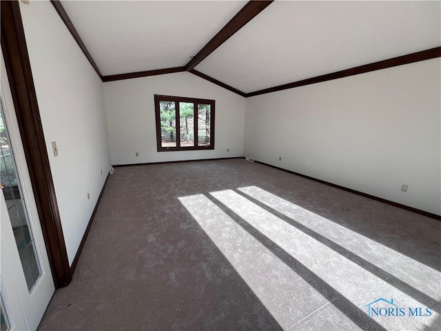 spare room featuring vaulted ceiling with beams, crown molding, baseboards, and carpet