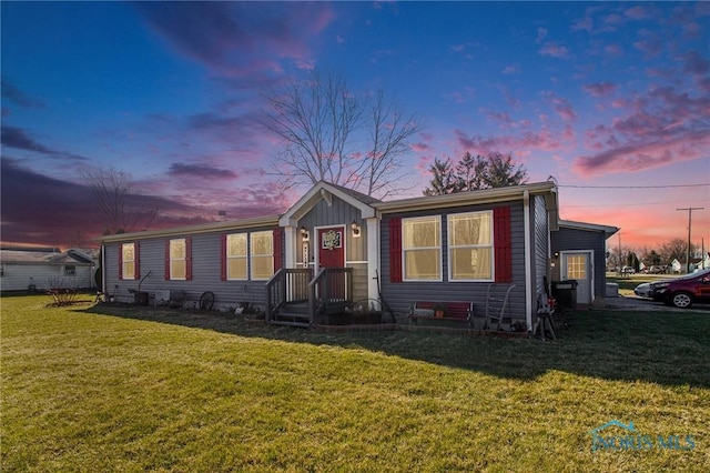 900 E Water St, North Baltimore, OH 45872 - view of front of house featuring board and batten siding and a front lawn