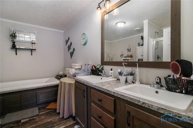 900 E Water St, North Baltimore, OH 45872 - full bathroom with a stall shower, a textured ceiling, a sink, and wood finished floors