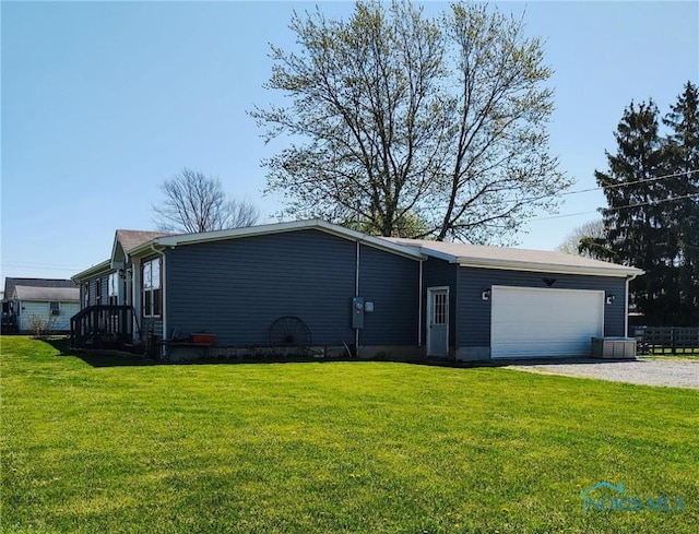 900 E Water St, North Baltimore, OH 45872 - view of front facade with a front lawn, gravel driveway, and an attached garage