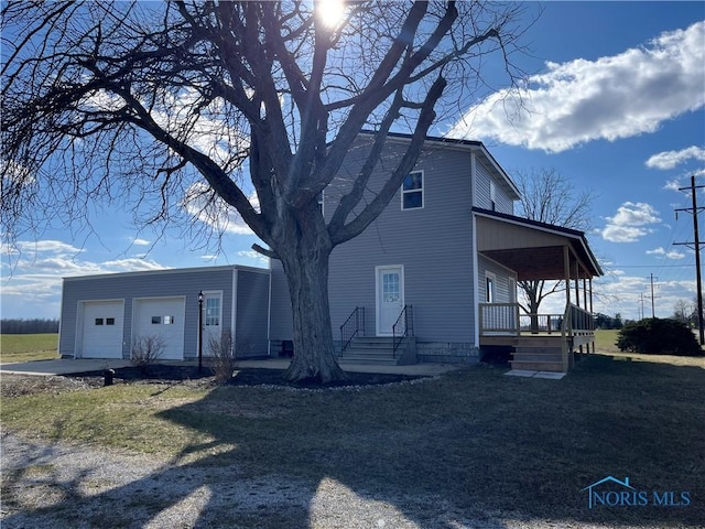 6888 County Road P50, Montpelier, OH 43543 - view of front facade with a porch, driveway, and a garage