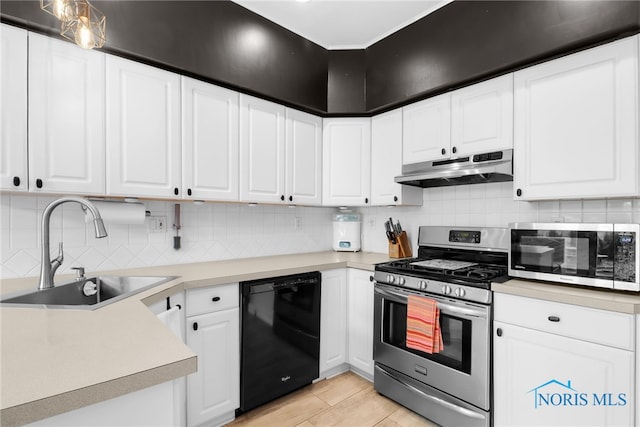 3063 Schneider Rd, Toledo, OH 43614 - kitchen featuring decorative backsplash, light countertops, appliances with stainless steel finishes, under cabinet range hood, and a sink