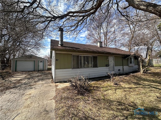 41 Dickens Dr, Toledo, OH 43607 - view of front of house with a detached garage, a chimney, an outdoor structure, and concrete driveway